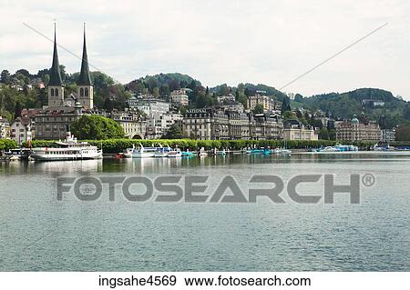 Stock Photo - Church spires of European town on riverbank . Fotosearch