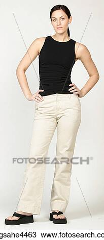 Stock Image - Confident young woman in casual attire. Fotosearch