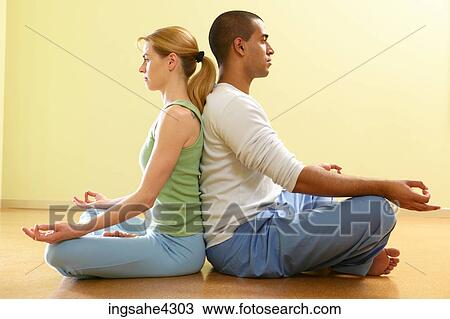 Couple sitting in lotus pose while practicing partner View Large Photo Image Stock Image - Couple sitting in lotus pose while practicing partner. Fotosearch