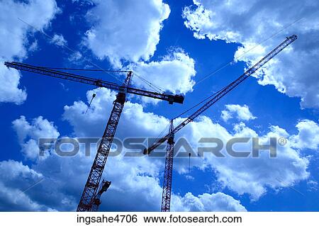 Cranes against blue sky View Large Photo Image Stock Photograph - Cranes against blue sky . Fotosearch