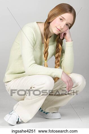 Stock Image - Crouching teenaged girl. Fotosearch