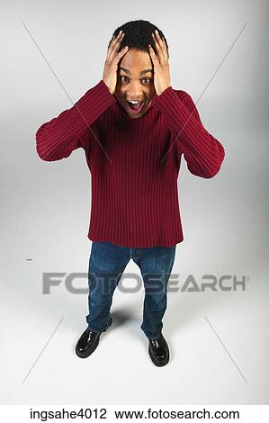 Excited man in jeans and red sweater View Large Photo Image Stock Image - Excited man in jeans and red sweater. Fotosearch
