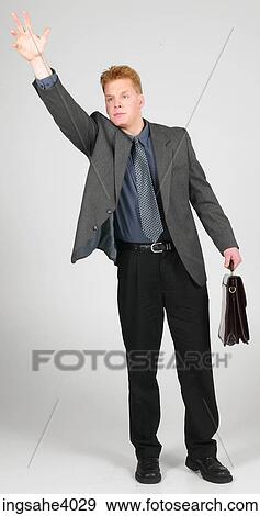 Executive holding a briefcase View Large Photo Image Stock Photo - Executive holding a briefcase . Fotosearch