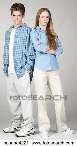 Stock Image - Frowning boy and girl standing beside each other. Fotosearch