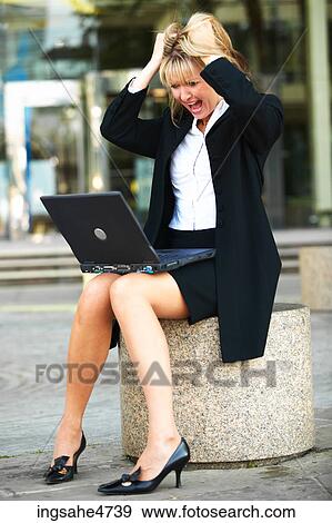 Stock Photo - Frustrated businesswoman with laptop . Fotosearch