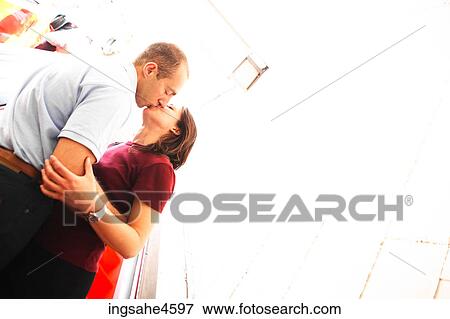 Kissing couple rid 1450619 View Large Photo Image Stock Photo - Kissing couple rid 1450619. Fotosearch