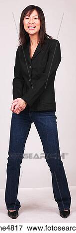 Stock Photo - Laughing young Asian woman holding her hands in front of her. Fotosearch