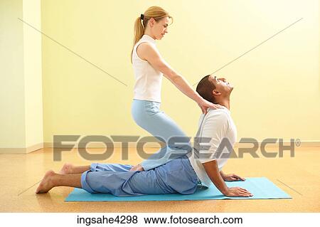 Man doing cobra pose with his yoga partner View Large Photo Image Stock Photo - Man doing cobra pose with his yoga partner. Fotosearch