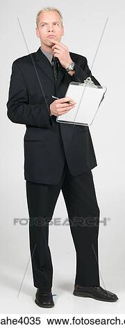 Stock Photography - Man holding a clipboard . Fotosearch