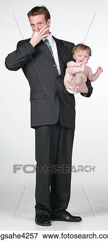 Man holding baby View Large Photo Image Stock Photo - Man holding baby . Fotosearch
