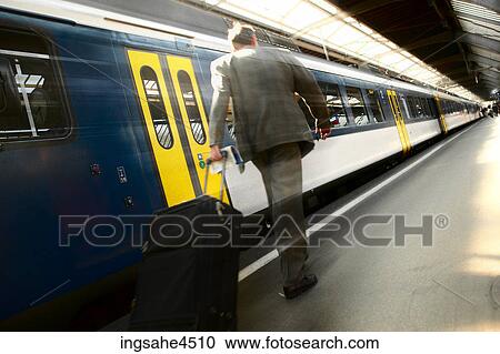 Man on train platform View Large Photo Image Stock Image - Man on train platform . Fotosearch