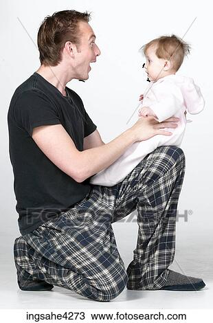 Man playing with baby View Large Photo Image Stock Image - Man playing with baby . Fotosearch