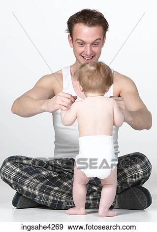 Man playing with baby View Large Photo Image Stock Photo - Man playing with baby . Fotosearch