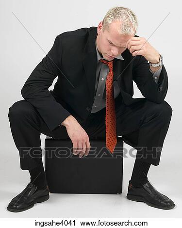 Man sitting on a briefcase View Large Photo Image Stock Image - Man sitting on a briefcase . Fotosearch