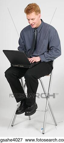 Stock Photo - Man sitting on a high chair . Fotosearch