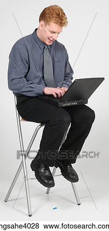 Man sitting on a high chair View Large Photo Image Stock Photo - Man sitting on a high chair . Fotosearch