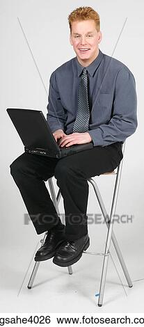 Man sitting on a high chair View Large Photo Image Stock Photograph - Man sitting on a high chair . Fotosearch