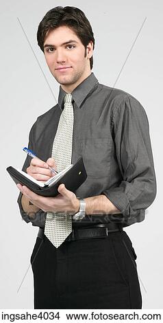 Man standing with a diary View Large Photo Image Picture - Man standing with a diary . Fotosearch