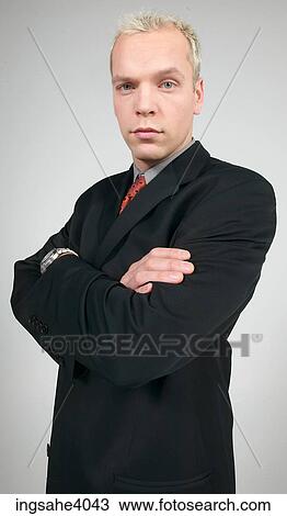 Man standing with his arms folded View Large Photo Image Stock Image - Man standing with his arms folded . Fotosearch