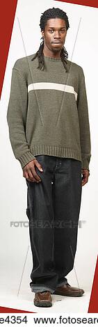 Picture - Man with dreadlocks wearing jeans and sweater. Fotosearch