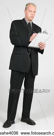 Stock Photograph - Man writing on a clipboard . Fotosearch