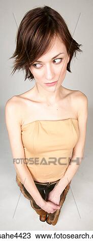 Stock Image - Nervous woman in brown outfit. Fotosearch
