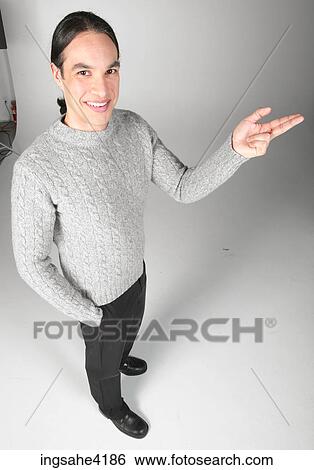 Stock Photograph - Pointing man in gray sweater. Fotosearch