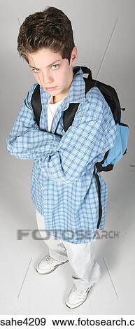 Pouting teenaged boy carrying backpack View Large Photo Image Stock Photo - Pouting teenaged boy carrying backpack. Fotosearch