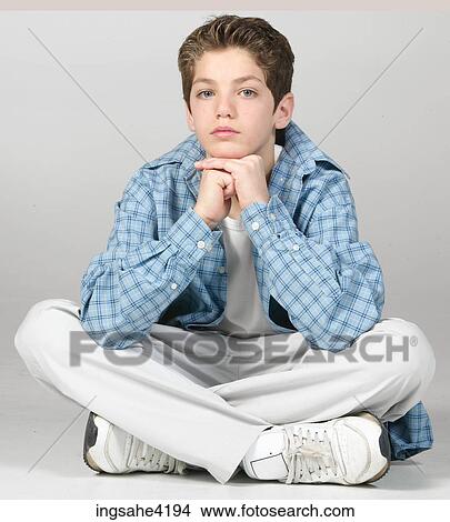 Seated teenaged boy in blue shirt View Large Photo Image Picture - Seated teenaged boy in blue shirt. Fotosearch