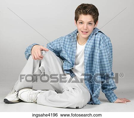 Seated teenaged boy in blue shirt View Large Photo Image Stock Photograph - Seated teenaged boy in blue shirt . Fotosearch