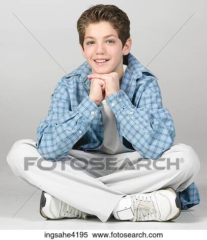 Seated teenaged boy in blue shirt View Large Photo Image Stock Photography - Seated teenaged boy in blue shirt . Fotosearch