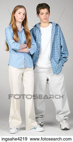 Serious boy and girl standing beside each other View Large Photo Image Stock Photo - Serious boy and girl standing beside each other. Fotosearch