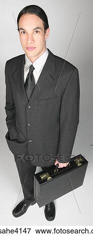 Stock Photo - Serious businessman holding briefcase . Fotosearch