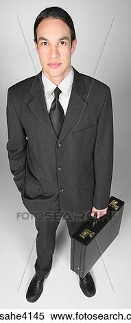 Serious businessman holding briefcase View Large Photo Image Stock Photography - Serious businessman holding briefcase. Fotosearch