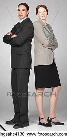 Stock Image - Serious businesspeople standing next to each other. Fotosearch