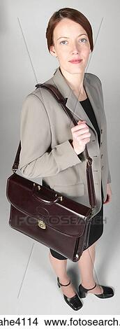 Picture - Serious businesswoman carrying briefcase. Fotosearch