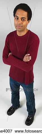 Stock Photo - Serious man in jeans and red sweater . Fotosearch