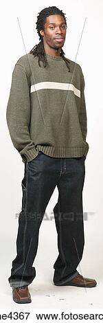 Serious man with dreadlocks in jeans and sweater View Large Photo Image Stock Photo - Serious man with dreadlocks in jeans and sweater . Fotosearch