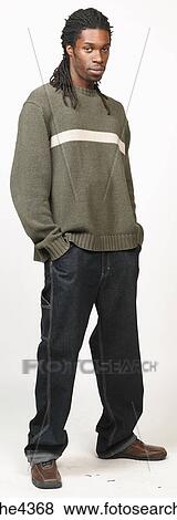 Serious man with dreadlocks in jeans and sweater View Large Photo Image Stock Photo - Serious man with dreadlocks in jeans and sweater. Fotosearch