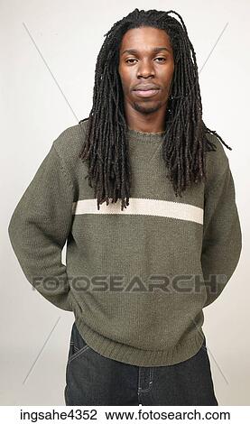 Serious man with dreadlocks wearing jeans and sweater View Large Photo Image Stock Image - Serious man with dreadlocks wearing jeans and sweater. Fotosearch
