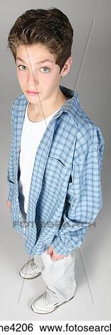 Serious teenaged boy in blue shirt View Large Photo Image Stock Photograph - Serious teenaged boy in blue shirt. Fotosearch