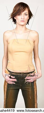 Stock Photo - Serious woman in brown outfit. Fotosearch