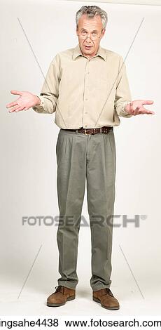 Shrugging middle-aged man in glasses View Large Photo Image Stock Photo - Shrugging middle-aged man in glasses. Fotosearch