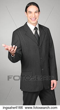 Stock Photograph - Smiling and gesturing businessman in gray suit. Fotosearch