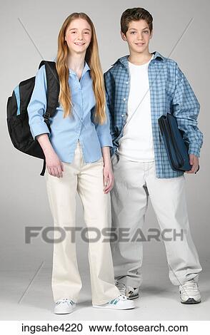 Smiling boy and girl carrying school bag and books View Large Photo Image Stock Image - Smiling boy and girl carrying school bag and books. Fotosearch