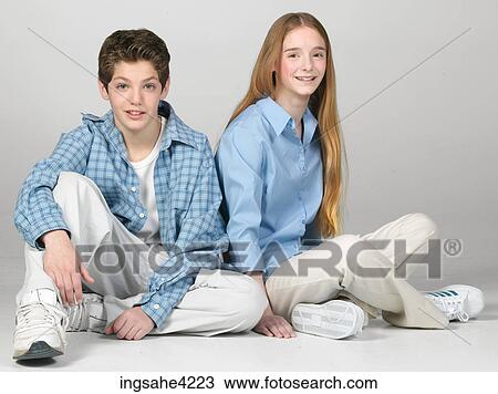 Smiling boy and girl sitting beside each other View Large Photo Image Stock Image - Smiling boy and girl sitting beside each other. Fotosearch