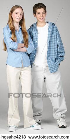 Smiling boy and girl standing beside each other View Large Photo Image Stock Photo - Smiling boy and girl standing beside each other. Fotosearch