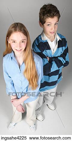 Stock Photography - Smiling boy and girl standing beside each other . Fotosearch