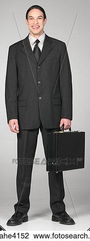 Stock Image - Smiling businessman carrying briefcase . Fotosearch