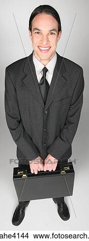 Smiling businessman holding briefcase View Large Photo Image Picture - Smiling businessman holding briefcase. Fotosearch